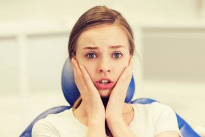Anxious young woman at orthodontics appointment